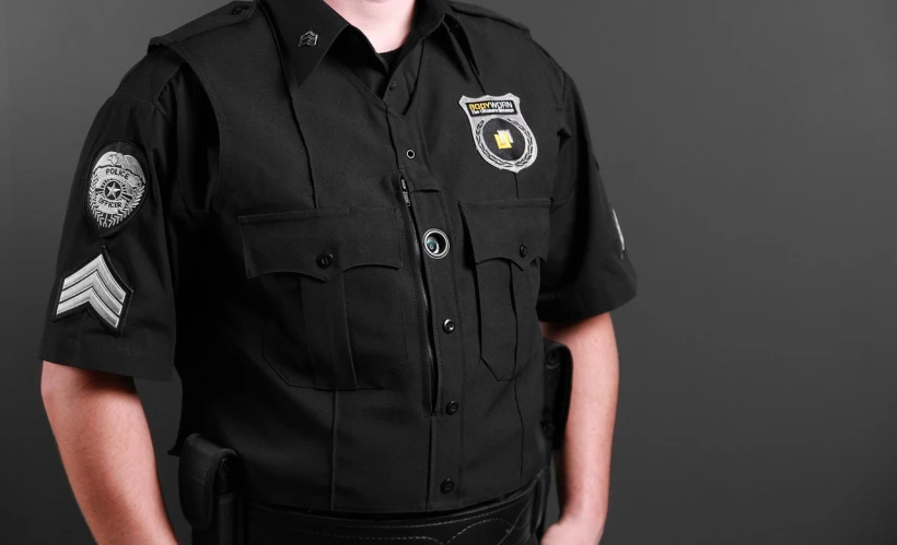 a man in a uniform posing for a picture, pexels, bodycam, badge on collar, an ultra realistic, highly detailed product photo