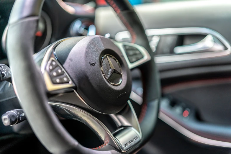 a close up of a steering wheel in a car, les automatistes, mercedez benz, sharp detailed focus, red and black details, thumbnail