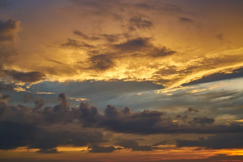 a group of people standing on top of a beach under a cloudy sky, a picture, romanticism, sunset panorama, yellow clouds, thunder clouds modernism, background heavenly sky