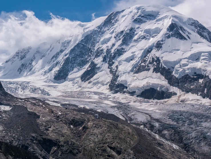 a group of people standing on top of a snow covered mountain, a detailed matte painting, by Werner Andermatt, shutterstock, icy glaciers, panoramic widescreen view, summer 2016, seen from a distance