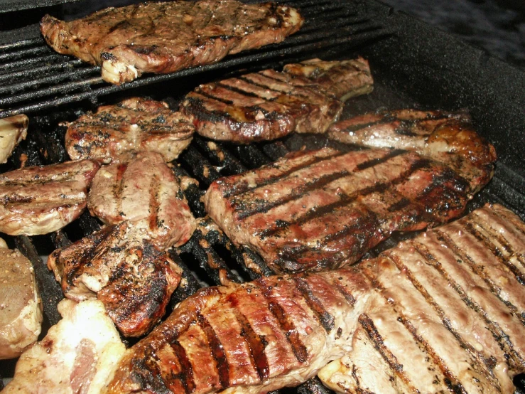 a bunch of meat is cooking on a grill, a photo, by Loren Munk, istockphoto, steak, stacked, bovine