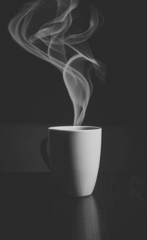 a steaming cup of coffee on a table, a black and white photo, minimalism, closeup portrait shot, dark backround, in the morning light, mid shot photo