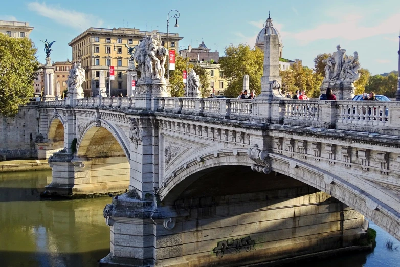 a bridge over a river with statues on it, by Bernardino Mei, shutterstock, neoclassicism, fall of rome, banner, urban surroundings, high detailed photo