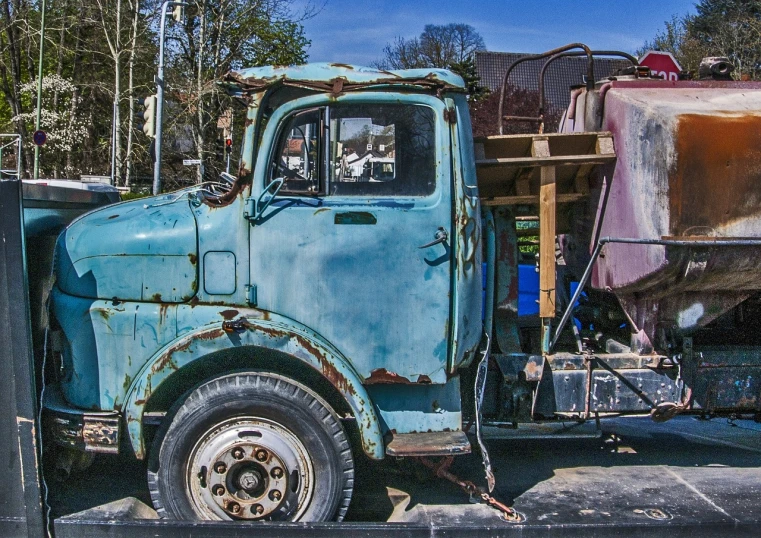 an old blue truck parked in a parking lot, by Arnie Swekel, flickr, photorealism, scrap metal, photorealism. trending on flickr, german, color ( sony a 7 r iv