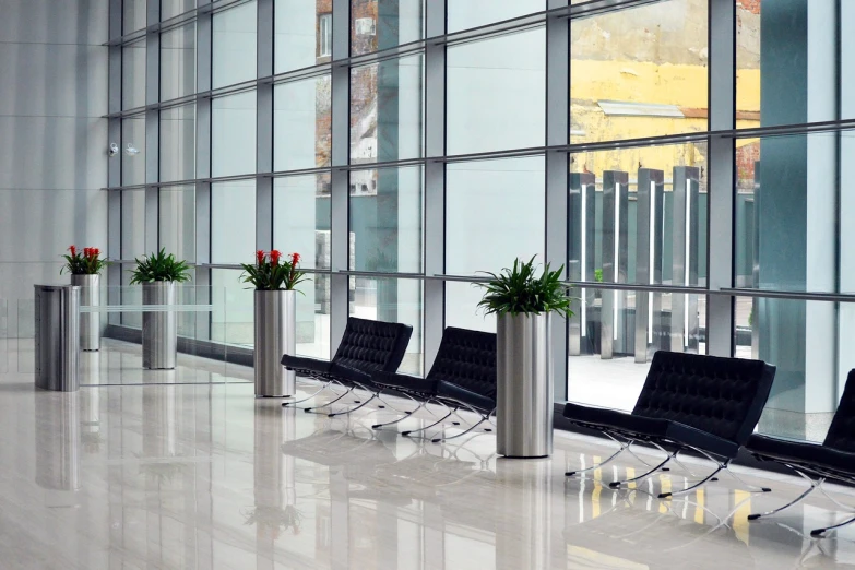 a row of chairs sitting in front of a window, by Arthur Sarkissian, glass ceilings, planters, clean medical environment, shiny floors