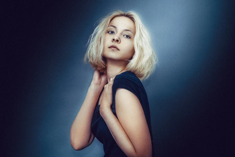 a woman in a black dress posing for a picture, a portrait, by Adam Marczyński, bleached blonde short hair, hana alisa omer, blue toned, sofya emelenko