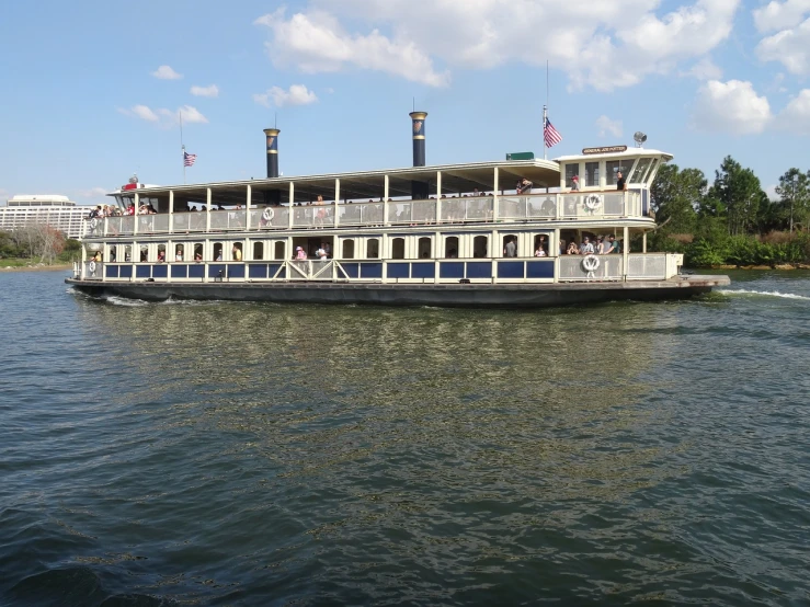 a large boat floating on top of a body of water, by Linda Sutton, steamboat willy, you can see all the passageways, nice afternoon lighting, a steam wheeler from 1880s