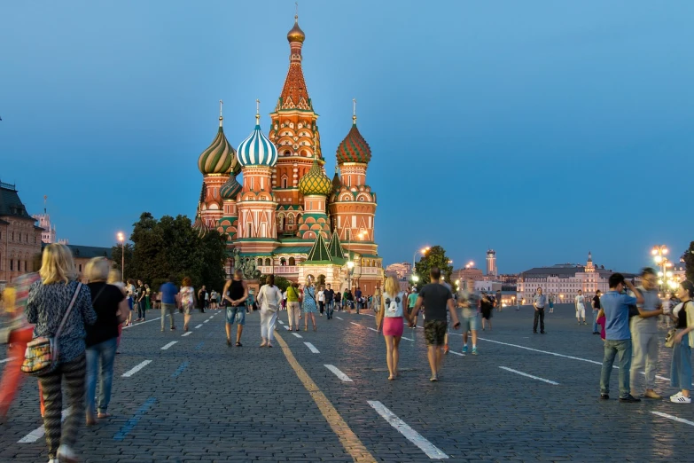 a crowd of people walking down a street next to a tall building, a picture, by Fyodor Rokotov, shutterstock, socialist realism, red square moscow, summer evening, russian temple, at the world cup