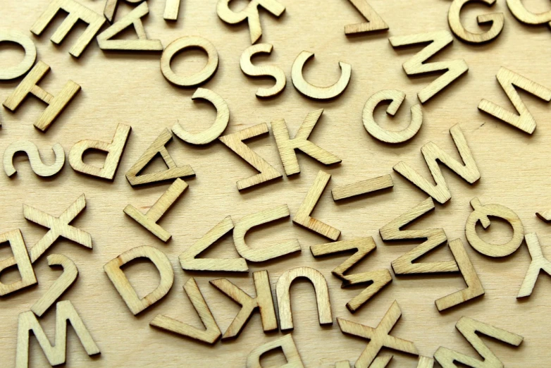 a pile of wooden letters sitting on top of a table, letterism, 3 mm, 3 4 5 3 1