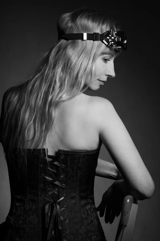 a black and white photo of a woman in a corset, a portrait, inspired by Jean-Jacques Henner, tumblr, baroque, portrait of kim petras, black iron crown, professional studio photograph, side-view