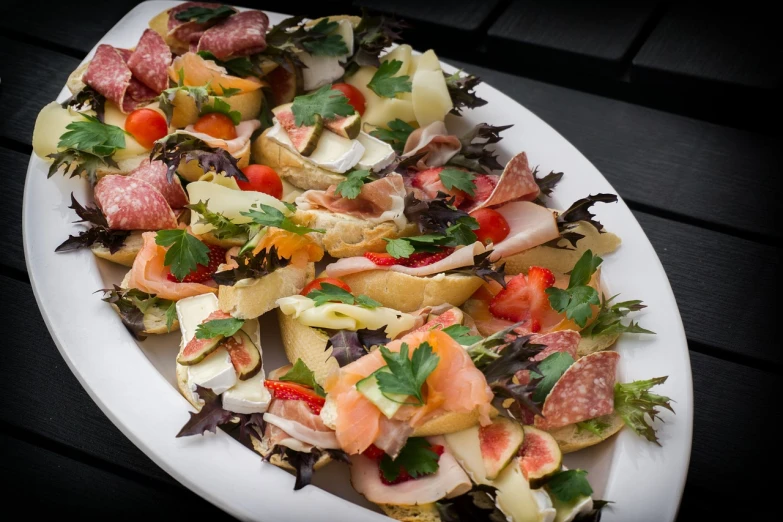 a close up of a plate of food on a table, a photo, by Dietmar Damerau, commercial product photography, sandwich, cornucopia, nachos