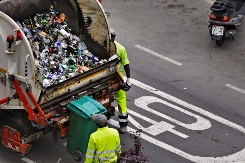 a man that is standing next to a garbage truck, a photo, by Matija Jama, shutterstock, plasticien, broken bottles, top down photo, workers, look at all that detail