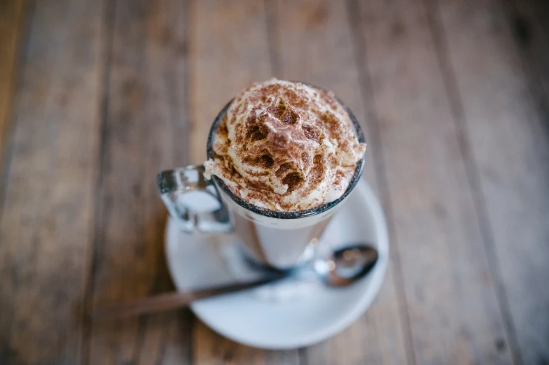 a close up of a cup of coffee on a saucer, by Lee Loughridge, pexels, renaissance, milkshake, fully chocolate, loosely detailed, clover