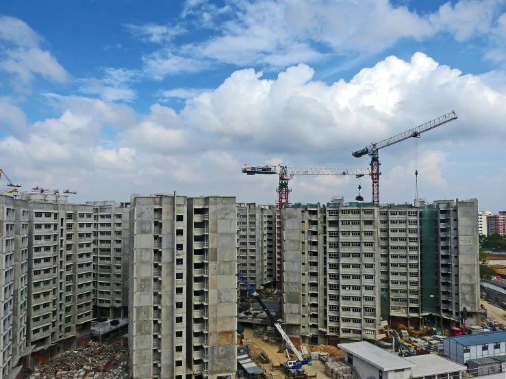 a building under construction with a crane in the background, by Joze Ciuha, shutterstock, south jakarta, view from high, concrete housing, wide long view