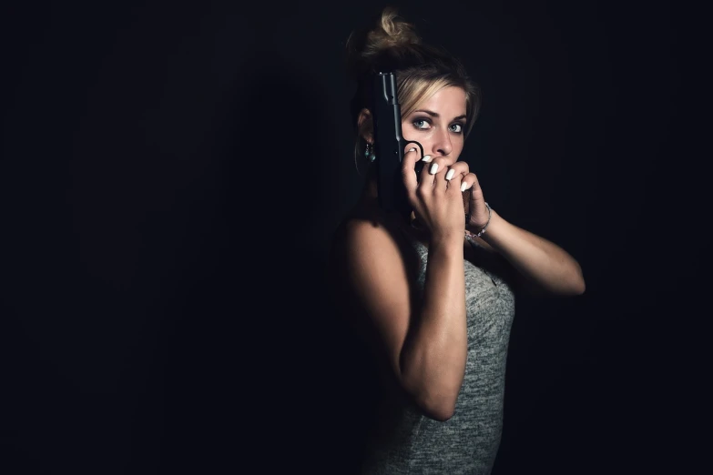 a woman holding a cell phone to her ear, by Matthias Weischer, holding gun down, low key, furious gorgeous woman, with a white muzzle