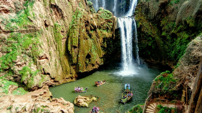 a group of people on small boats in front of a waterfall, pexels, les nabis, moroccan, !!beautiful!!, fitness, heaven on earth