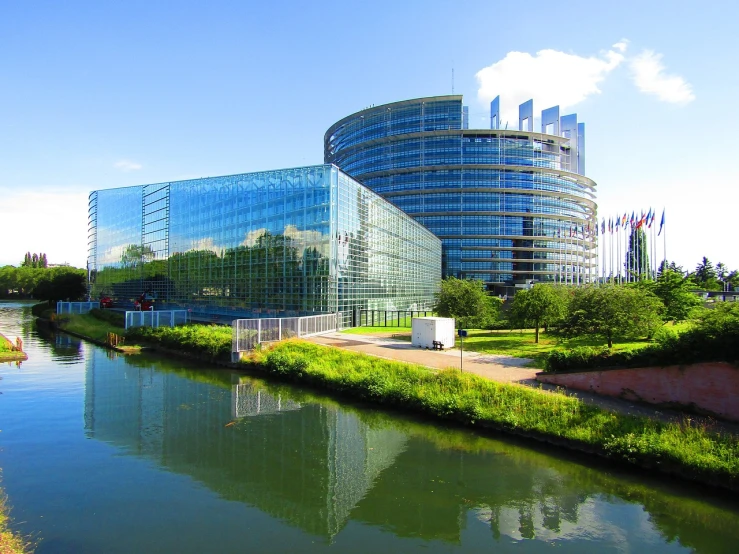a body of water with a building in the background, a photo, by Jakob Gauermann, flickr, renaissance, european union, a huge glass tank, european union flag, modern high sharpness photo