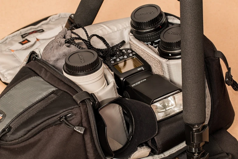 a close up of a camera in a bag, a portrait, by Randy Post, pockets, focus stacking, thievery equipment, 8 k. filling of the view