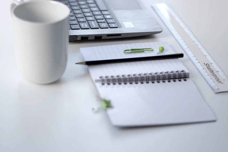 a cup of coffee sitting on top of a desk next to a laptop, minimalism, highly detailed product photo, linux mint, pencil and paper, modern very sharp photo