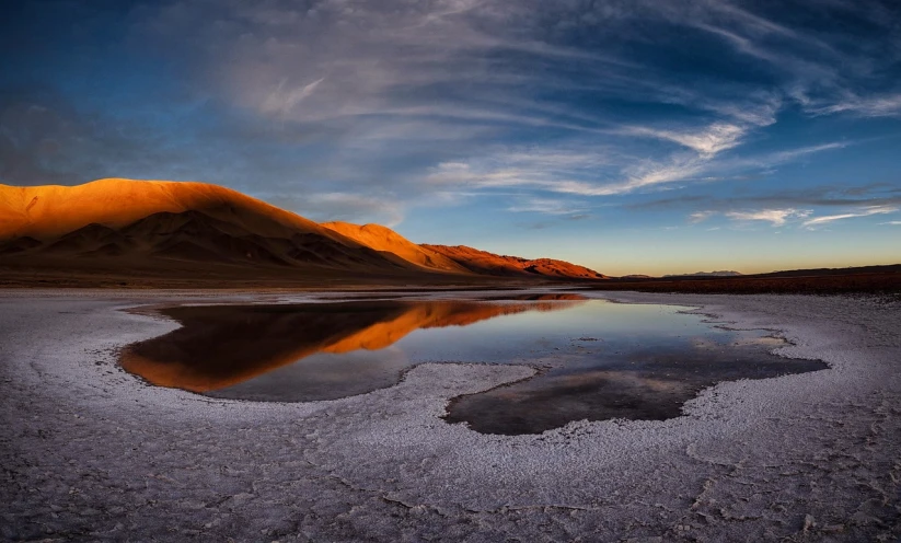 a body of water with a mountain in the background, a picture, by Niklaus Manuel, desert colors, marvellous reflection of the sky, panoramic photography, award-winning photo uhd