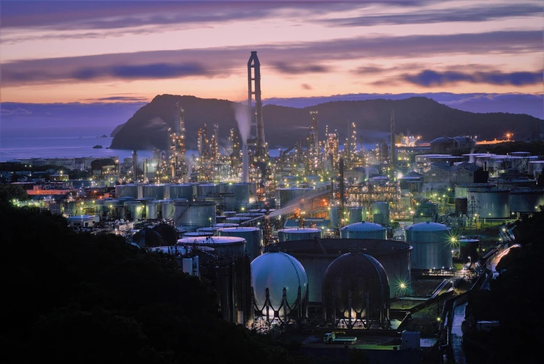 a large oil refinery at dusk with mountains in the background, by Tadashi Nakayama, flickr, process art, golden bay new zealand, worksafe. instagram photo, japanese city at night, wallpaper - 1 0 2 4