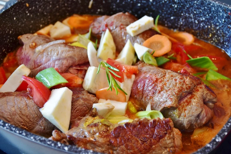 a pan filled with meat and vegetables on top of a stove, a pastel, by Juan O'Gorman, pixabay, dau-al-set, lomo saltado, high texture detail, bone, stuffed