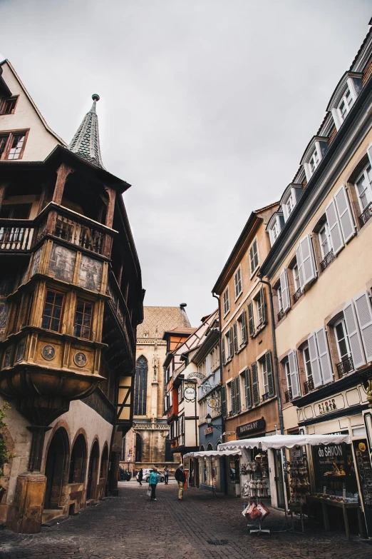 a couple of buildings that are next to each other, a photo, renaissance, in a medieval city, french architecture, shot on canon camera, wooden structures