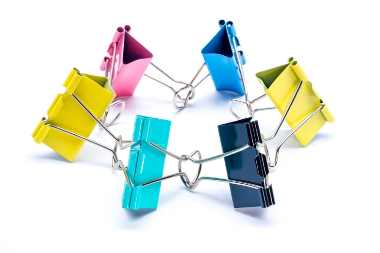 a group of colorful binders sitting on top of each other, assemblage, chain, 85mm, clamp, productphoto