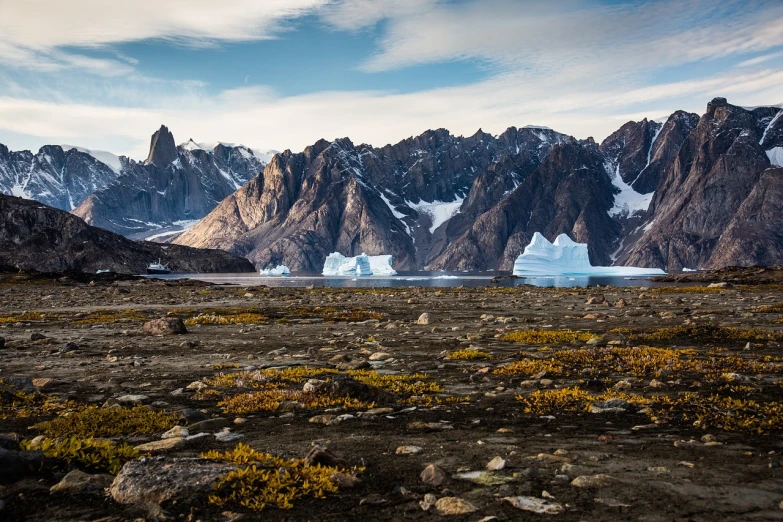 a mountain range with icebergs in the distance, by Dietmar Damerau, shutterstock, rocky grass field, epic composition 8 5 mm, inuit, 5 0 0 px