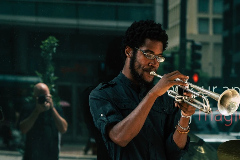 a man playing a trumpet on a city street, inspired by Gordon Parks, pexels contest winner, avatar image, man with glasses, alabama, usa-sep 20