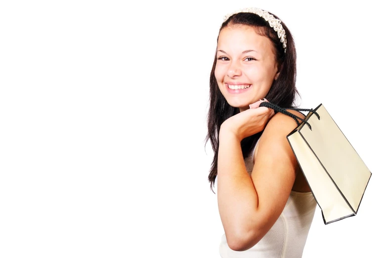 a woman in a white dress holding a bag, a photo, istockphoto, happy girl, customers, wearing a paper crown