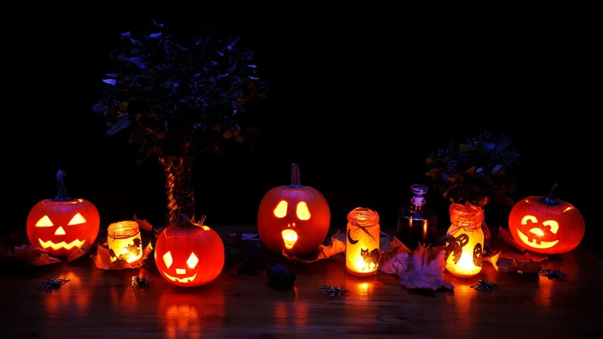 a group of carved pumpkins sitting on top of a wooden table, a picture, lights in the dark, lamps on ground, profile image, potions