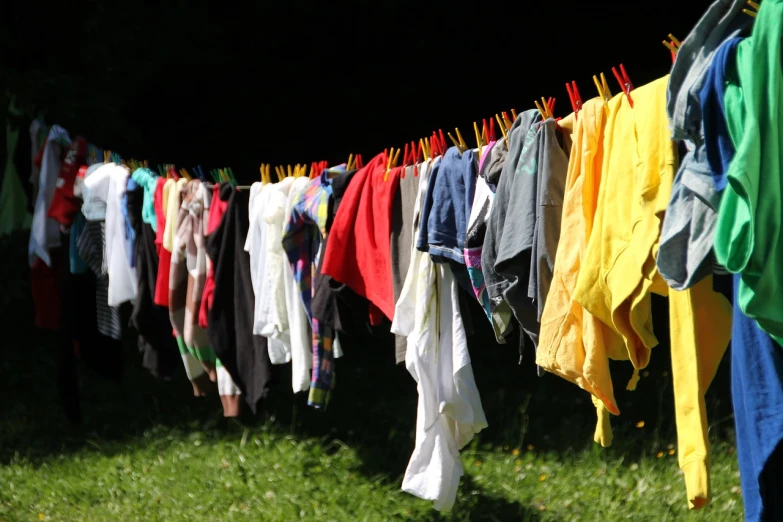 a line of clothes hanging on a clothes line, by Werner Gutzeit, process art, 15081959 21121991 01012000 4k, having fun in the sun, washing machine, hiking clothes