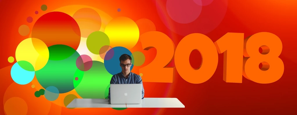 a man sitting in front of a laptop computer, a digital rendering, trending on pixabay, bright colors with red hues, year 2 0 4 0, colorful ideas, he is about 2 0 years old