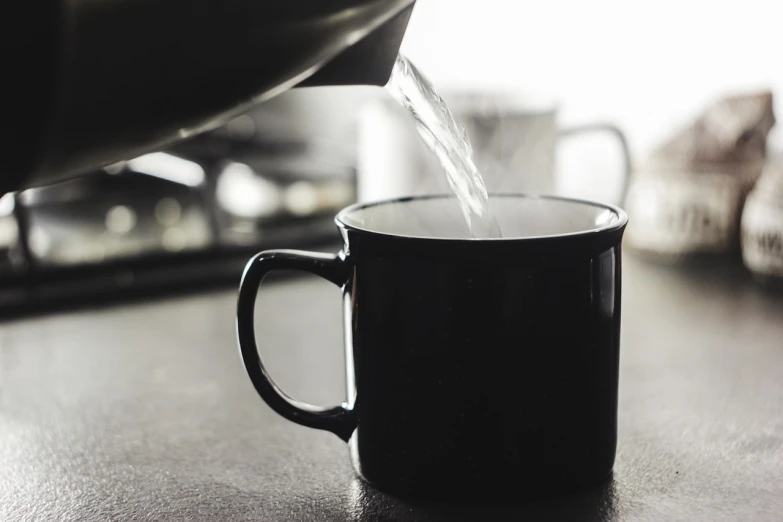 a coffee pot pouring water into a cup, by Jesper Knudsen, pexels, white mug, black, slightly realistic, information