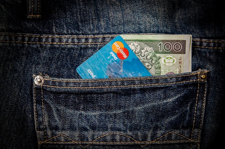 a credit card sticking out of a pocket, a photo, by Géza Dósa, renaissance, photorealism. trending on flickr, nepal, blue pants, a colorful