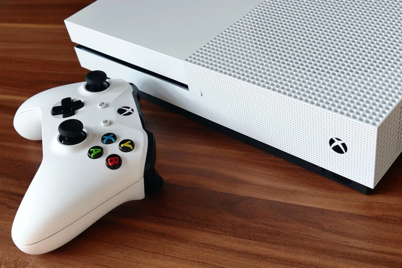 a white xbox one sitting next to a game controller, pixabay, hypermodernism, looking partly to the left, board games on a table, the console is tall and imposing, fresh modern look
