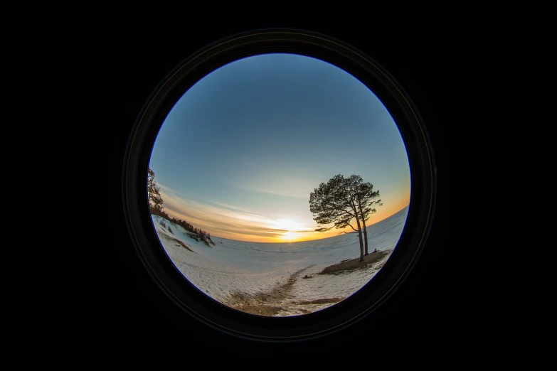 a view of a sunset through a round window, by Olaf Gulbransson, wide angle 15mm lens, winter setting, very accurate photo, portal 3