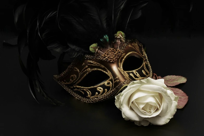 a close up of a mask and a rose on a table, inspired by Hedi Xandt, pixabay contest winner, romanticism, cinematic 4k wallpaper, golden feathers, beautiful iphone wallpaper, caravaggio style