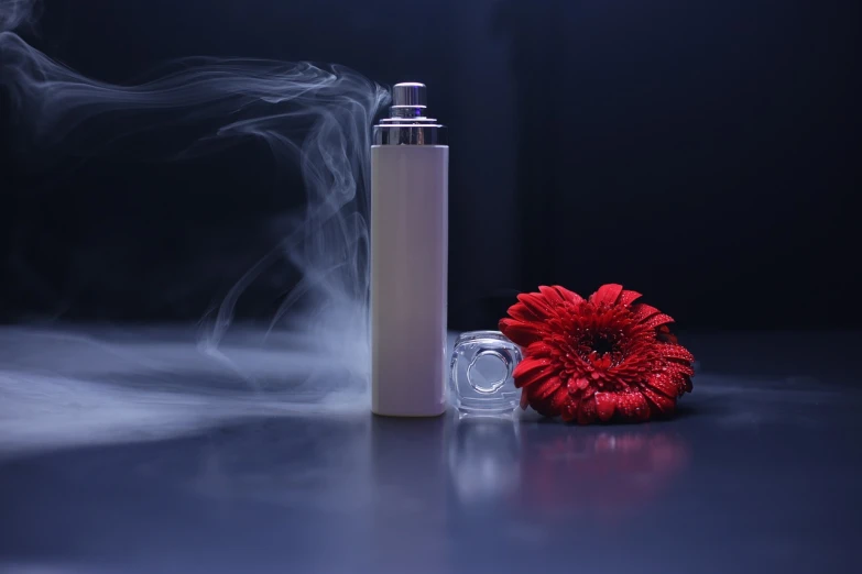 a white spray bottle sitting next to a red flower, by Tadashi Nakayama, shutterstock, romanticism, smoke and gas, cosmetics, product introduction photo, high quality product photo