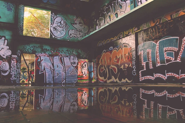 a room filled with lots of graffiti covered walls, unsplash, graffiti, reflecting pool, retro effect, bunker, ((oversaturated))