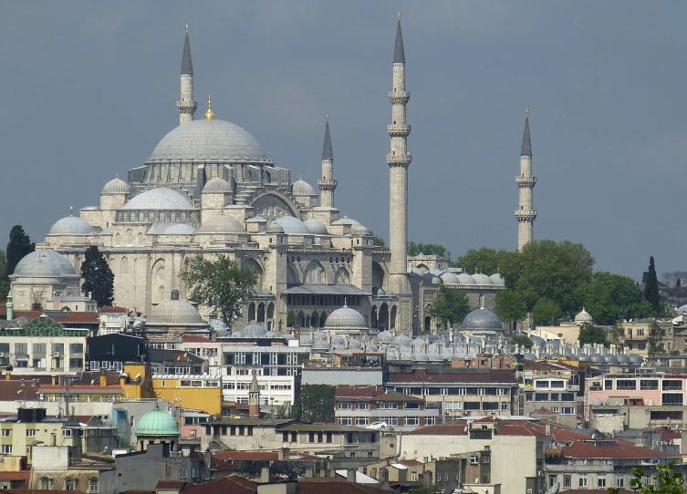 a large white building sitting in the middle of a city, by Cafer Bater, flickr, hurufiyya, with great domes and arches, istanbul, spire, sunday