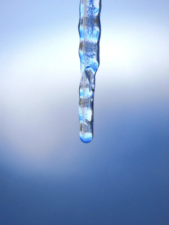 a close up of water dripping from a faucet, by Jan Rustem, blue ice, 3/4 view from below, istockphoto, filmed in 70mm