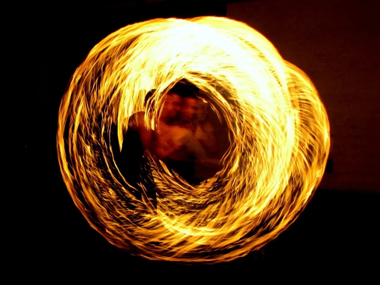 a fire spinning around in the dark, a picture, by Erwin Bowien, flickr, yellow aureole, serpent, shot on 3 5 mm, hasanabi