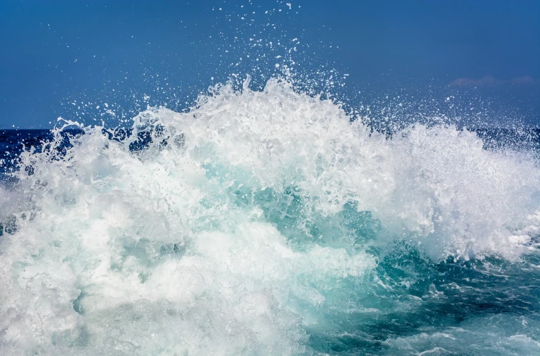 a man riding a wave on top of a surfboard, by Edward Corbett, pexels, wave of water particles, photo taken from a boat, blue crashing waves, la nouvelle vague