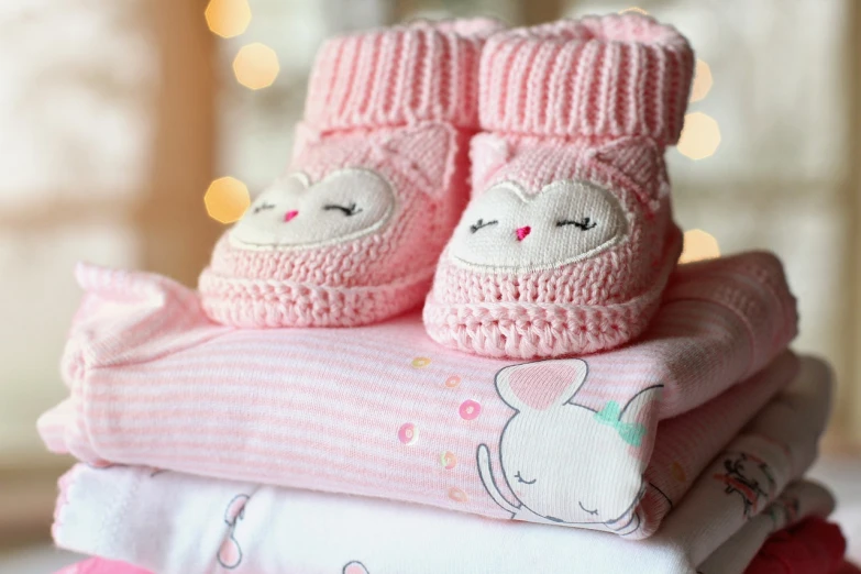 a stack of baby clothes sitting on top of each other, by Alexander Brook, pexels, pink shoes, cute owl, wintertime, avatar image