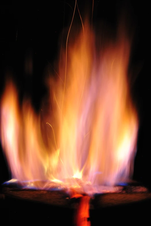 a close up of a fire in the dark, a picture, by Jan Rustem, istockphoto, a brightly colored, shot on a 2 0 0 3 camera, unwind!