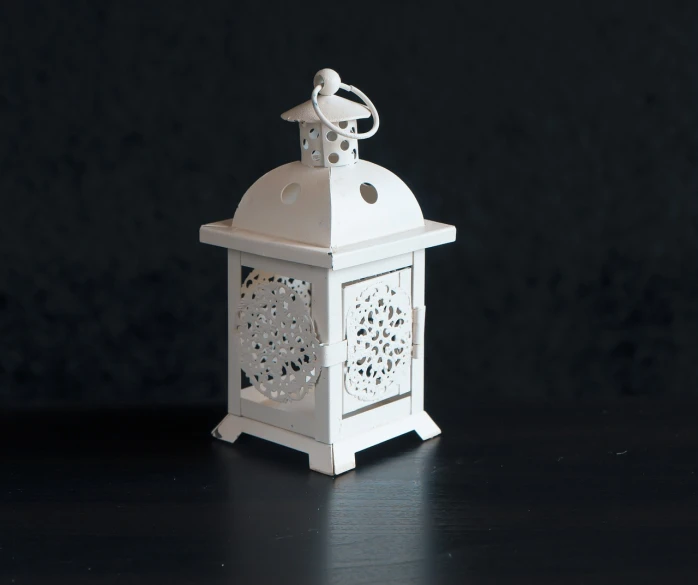 a white lantern sitting on top of a table, arabesque, professional product photo, highly detailed product photo, high details photo, miniature product photo