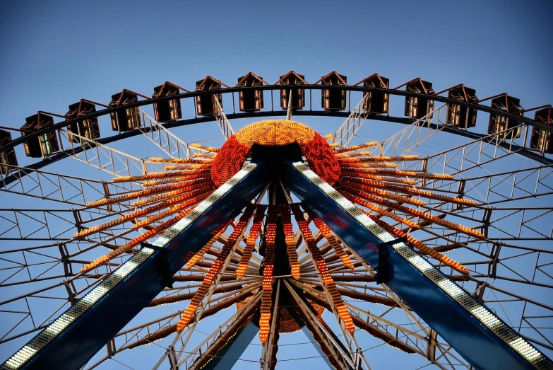 a ferris wheel with a blue sky in the background, by Matthias Weischer, aestheticism, blue and orange rim lights, 3 4 5 3 1, highly realistic photography, bottom - view