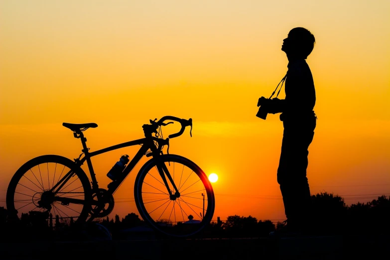 a man standing next to a bike at sunset, a picture, by Tom Carapic, photostock, 1 st winner, taking a picture, istockphoto